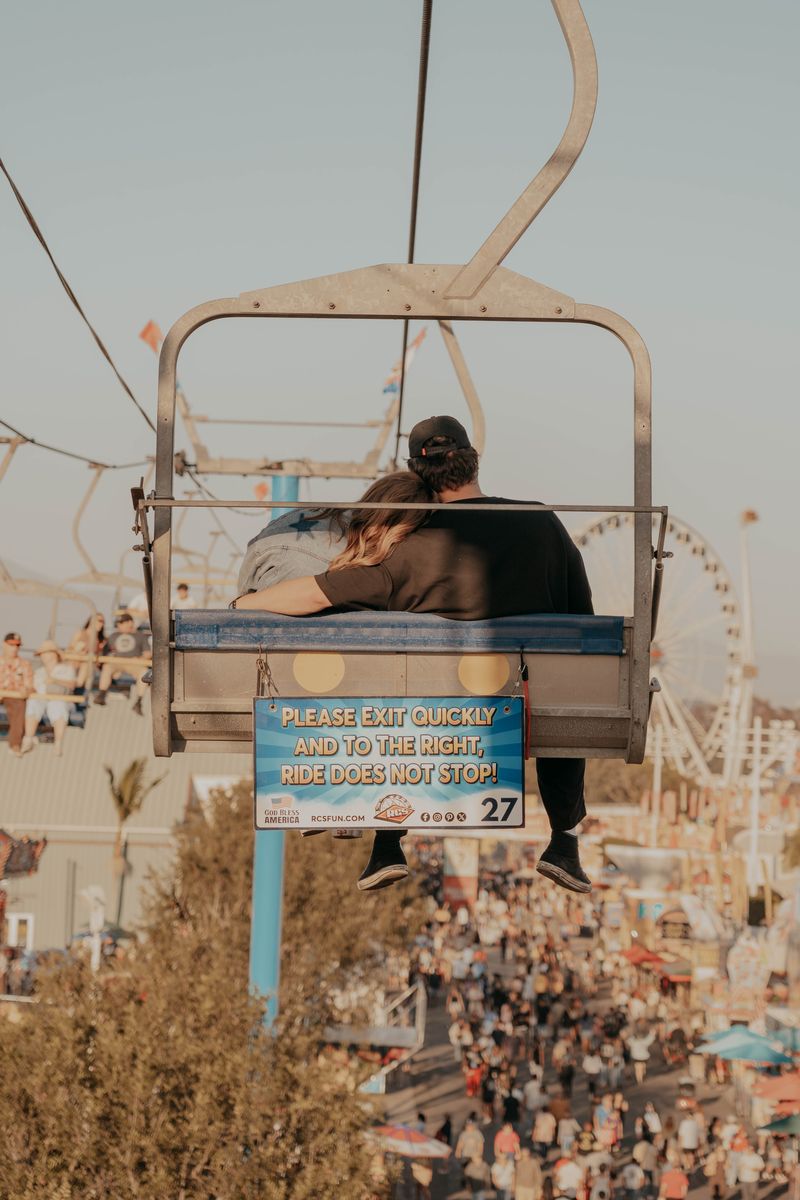 Ryan and Rachel riding the sky lift over the fairgrounds at golden hour