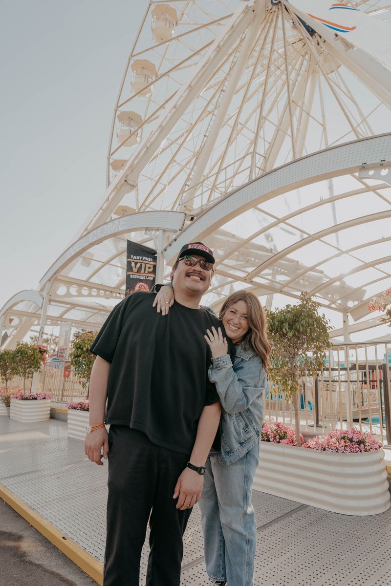Ryan and Rachel standing together in front of the Ferris wheel