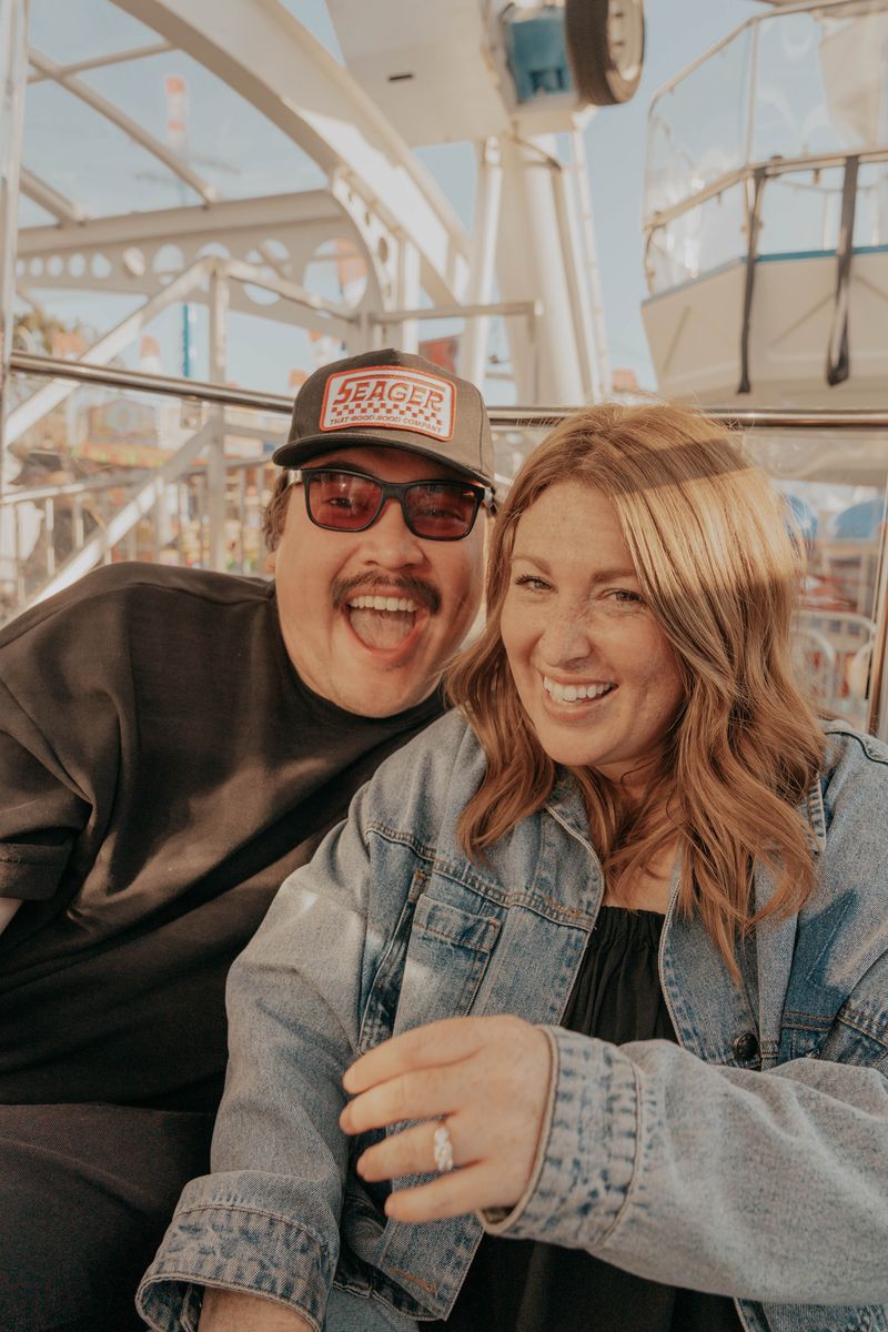 Rachel laughing close to Ryan, engagement ring visible
