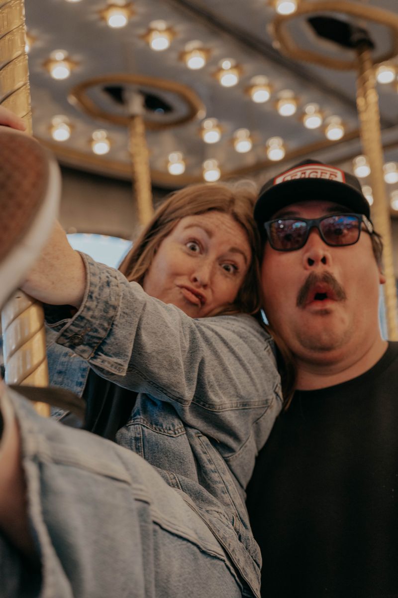 Ryan and Rachel taking a selfie under the fair lights