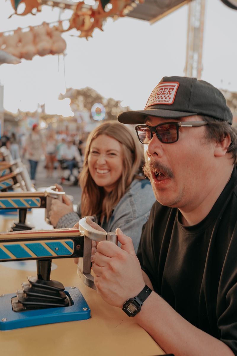 Ryan and Rachel at a fair table, laughing